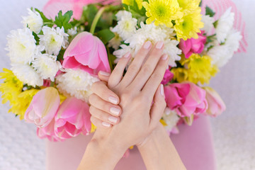 ideally made manicure and pedicure. Women's legs and hands on the background of flowers