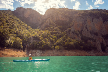 Fototapeta na wymiar Woman on a kayak in the Pyrenees mountains in Catalonia