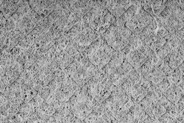 Household cleaning sponges closeup. Sponge detail texture, sponge texture close up background. Cellulose sponge texture. Wire mesh on sponge surface background. Black and white