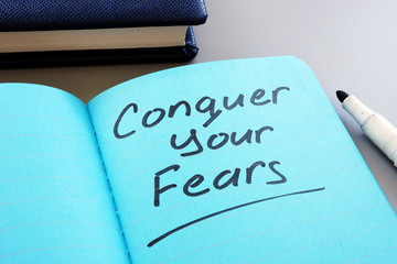 Conceptual hand writing text showing Conquer your fears