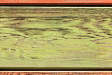 Abstract multicolored colorful horizontal striped background in beautiful pastel autumn colors with the surface texture of wooden boards painted in green light green yellow orange
