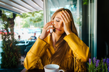 Portrait of young beautiful woman at cafe restaurant talking to the mobile phone call receiving...