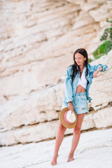 Woman laying on the beach enjoying summer holidays looking at the sea