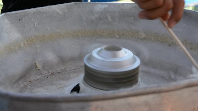 candy floss machine at work. Machine making cotton candy at the festival.