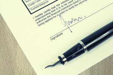 Signature on a contract. Vintage filtered color style.