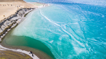 Blue Ice surface of Frozen Lake from drone aerial view at Pangong Lake or Pangong Tso, Tso moriri...