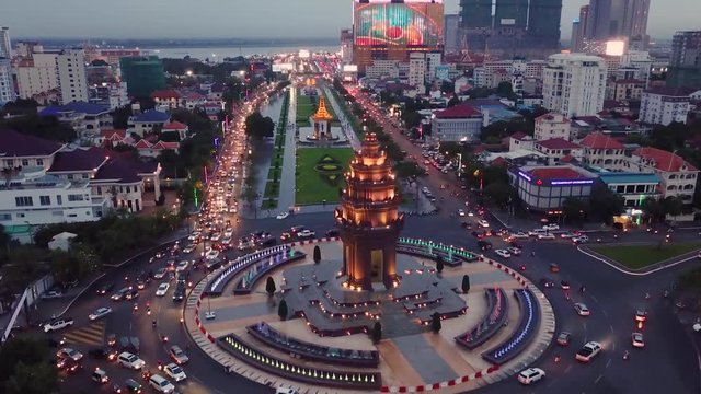 Aerial shot showing bright lights and traffic above the Independence Monument in Phnom Penh, Cambodia.
