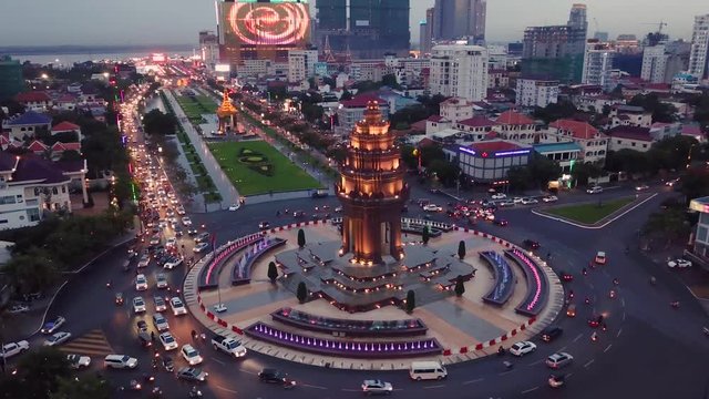 Aerial shot showing bright lights and traffic above the Independence Monument in Phnom Penh, Cambodia.
