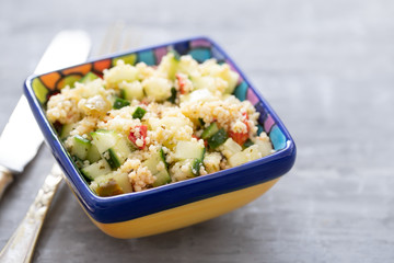 tabbouleh in small bowl on ceramic background