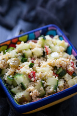tabbouleh in small bowl on ceramic background