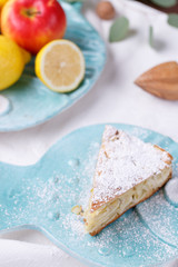 apple pie on a blue plate. lemon with apples