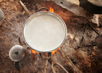 boiling goat milk on the stove