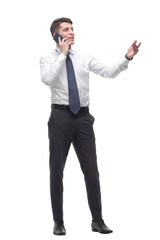 successful young businessman talking on mobile phone. isolated on white