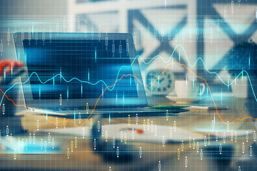 Financial graph colorful drawing and table with computer on background. Double exposure. Concept of international markets.