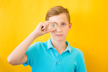 Handsome boy looks through a glass prism. Medical, vision and implantation concept