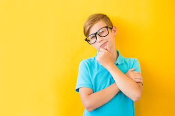 Photo of adorable young happy boy looking at camera and winks with one eye