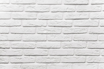 Fototapeta premium long white brick wall. The texture of the old brick painted with white paint