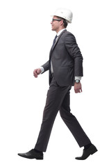 rear view. young businessman in a protective helmet confidently stepping forward