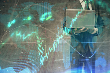 Forex graph with businessman working on laptop on background. Concept of hardworking. Multi exposure.