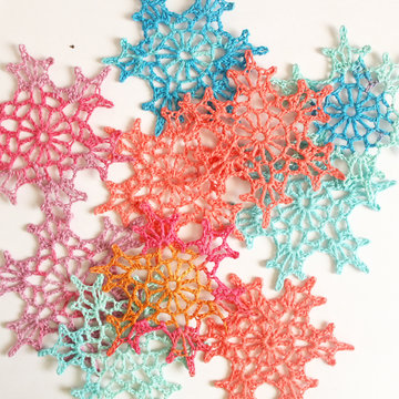 Crochet decorations, snowflakes for new year and Christmas of different colors.