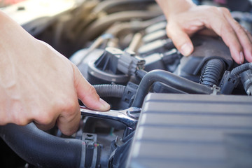 The engine engineer is checking and repairing the car.