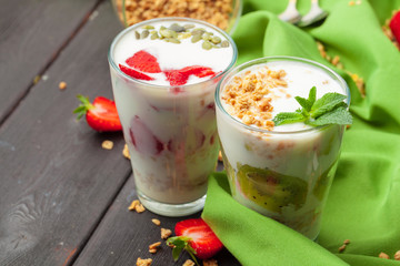 Healthy summer breakfast. Jar with granola, yoghurt and strawberry