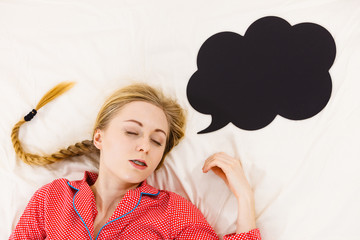 Young woman lying on bed wearing pajamas