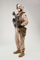 United states Marine Corps special operations command  raider with weapon. Studio shot