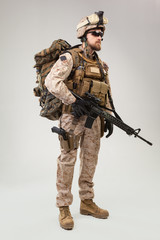 Portrait of a young American US Marine Corps soldier over grey background