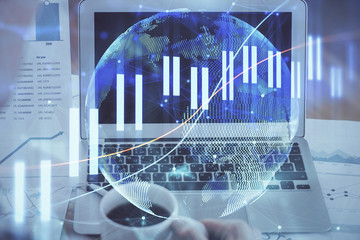 Stock market graph and table with computer background. Multi exposure. Concept of financial analysis.
