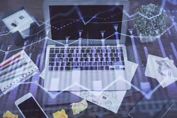 Financial graph colorful drawing and table with computer on background. Double exposure. Concept of international markets.