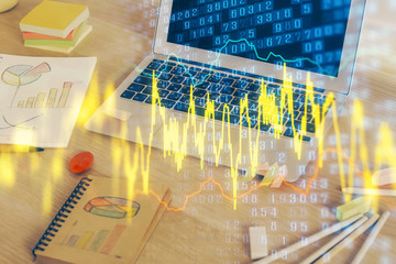 Double exposure of chart and financial info and work space with computer background. Concept of...