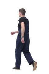 smiling man in overalls goes forward.isolated on white