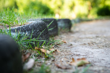 Tires with grass in the city street close up
