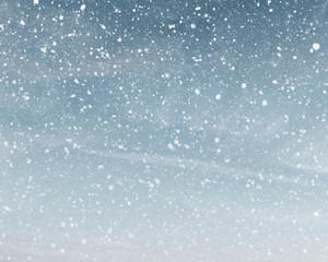 Snowfall in cloudy blue sky - obrazy, fototapety, plakaty