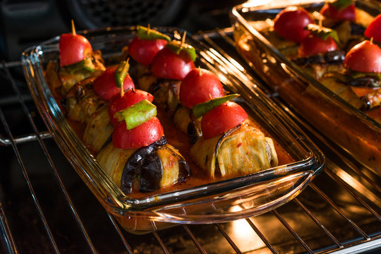 Turkish Islim Kofta Kebab with Meatballs and Cherry Tomatoes Wrapped in Eggplant / Aubergine Slices on Oven Tray.