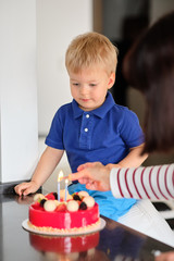 Two year old boy with birthday cake
