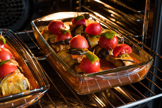 Turkish Islim Kofta Kebab with Meatballs and Cherry Tomatoes Wrapped in Eggplant / Aubergine Slices on Oven Tray.
