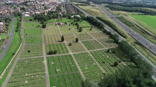 Static aerial footage over Old Monkland Cemetery at Coatbridge. Traffic passing on the M8 motorway.