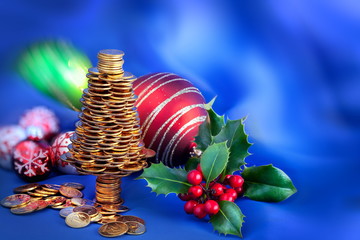 Golden happy  Christmas tree with  many golden coins on blue blur background, business metaphor   