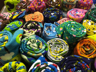 Fototapeta na wymiar Multicolored rolls of cotton fabric in assortment on market