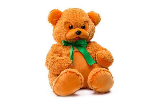 Image of brown toy teddy bear sitting at white isolated background.