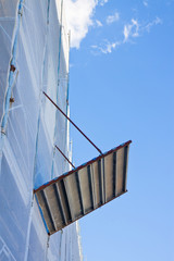 Metal scaffolding with plastic grid for the restoration of a building facade in a italian...