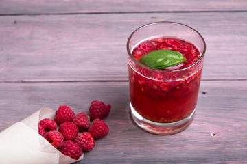 Glass of fresh strawberry summer cocktail and strawberries on the wooden background. Healthy food and drink concept.