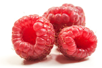 Close up of three fresh raspberrys on the white