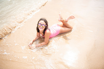 Pretty girl with her sunglasses on the beach