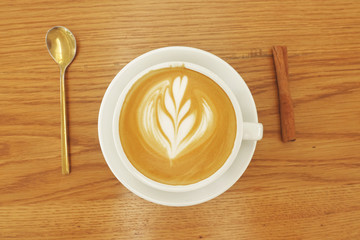 a cup of latte art coffee on wooden background                              