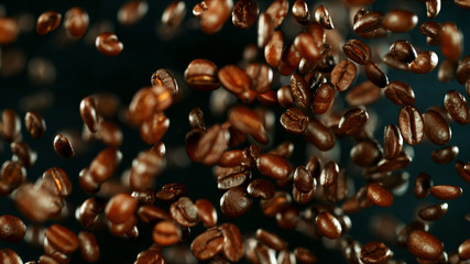 Obraz premium Fresh roasted coffee beans flying in the air