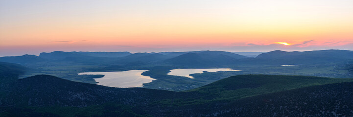 the view of two lakes from the height of the mountain, in the light of the setting sun, the clear...