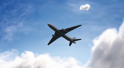 Fototapeta na wymiar Blank black airplane mockup on sky background, bottom view